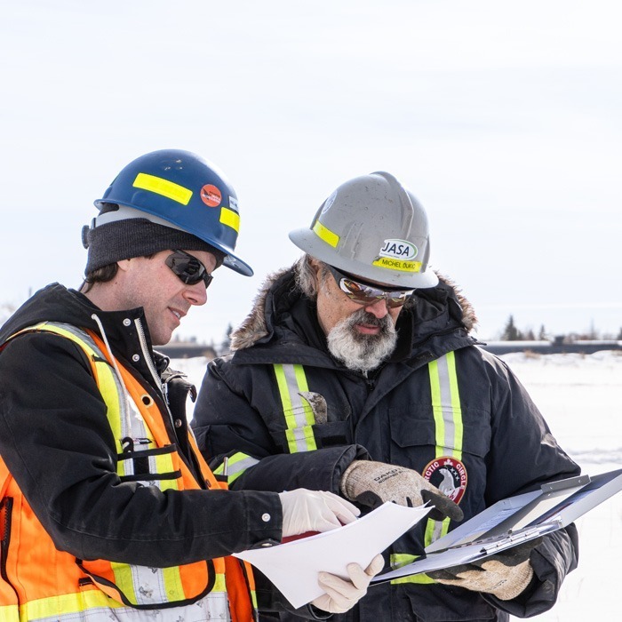 Inline Group staff members reviewing documents in the field