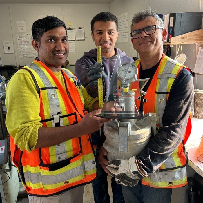 Inline Group staff holding an award
