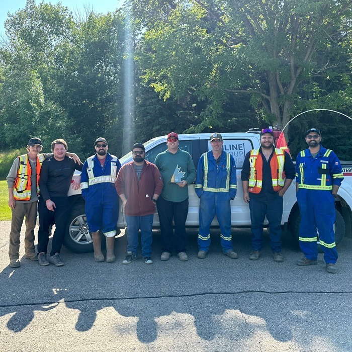 Inline Group staff holding an award