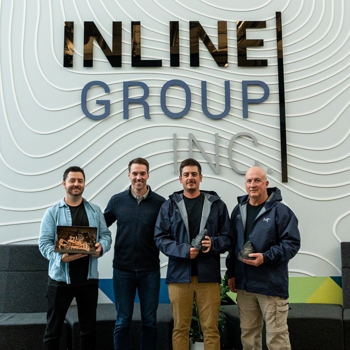 Inline Group staff holding an award